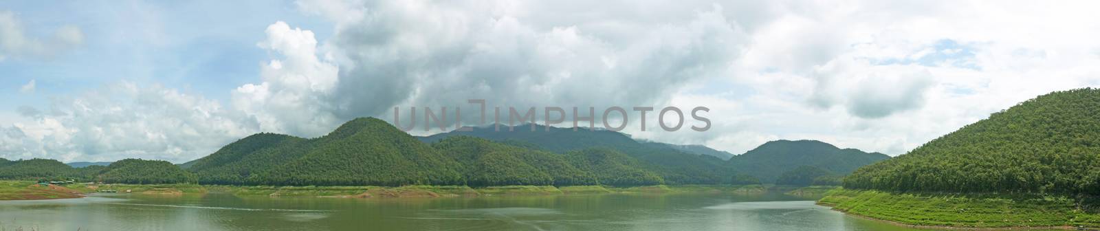 Natural forest landscape mountains sky water clouds.