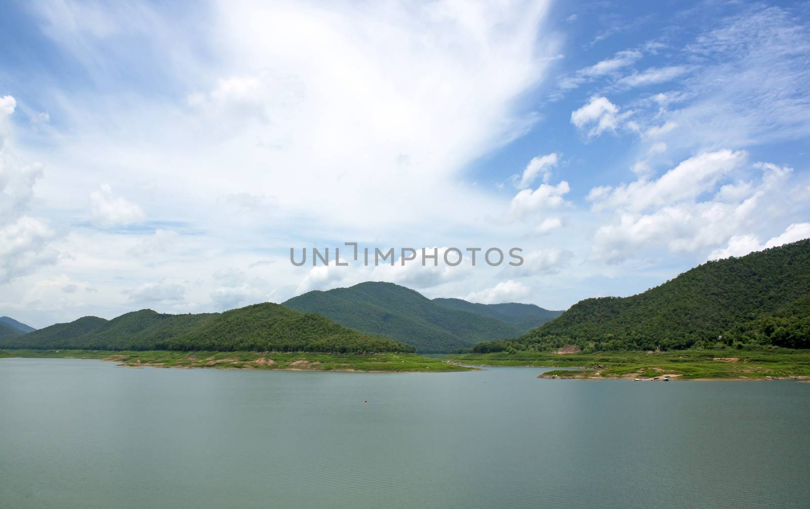 Natural forest landscape mountains sky water clouds.