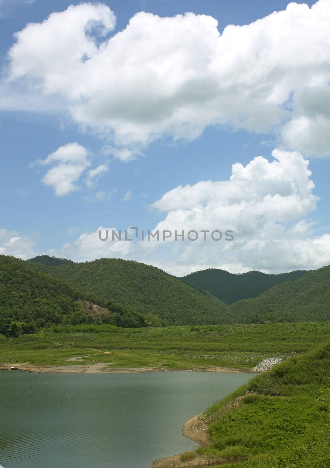 Natural forest landscape mountains sky water clouds.