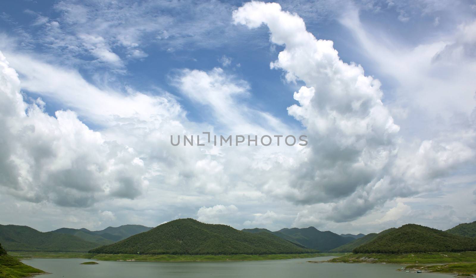 Natural forest landscape mountains sky water clouds.