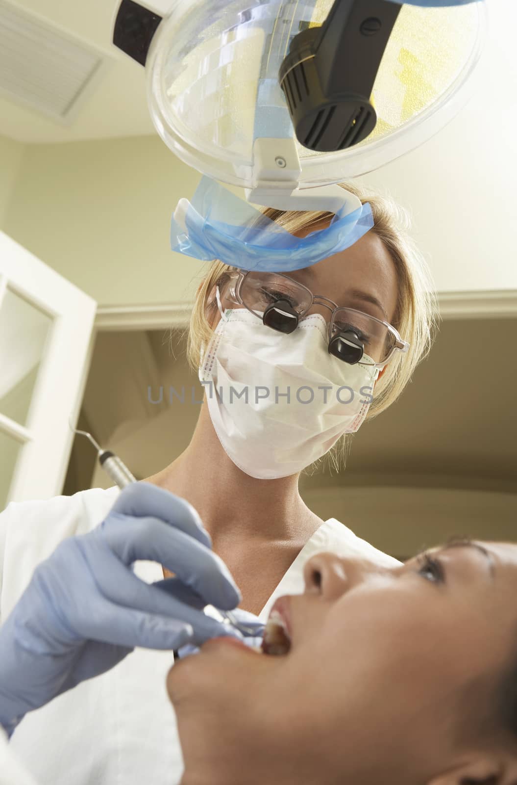 Female patient being examined by dentist at clinic by moodboard
