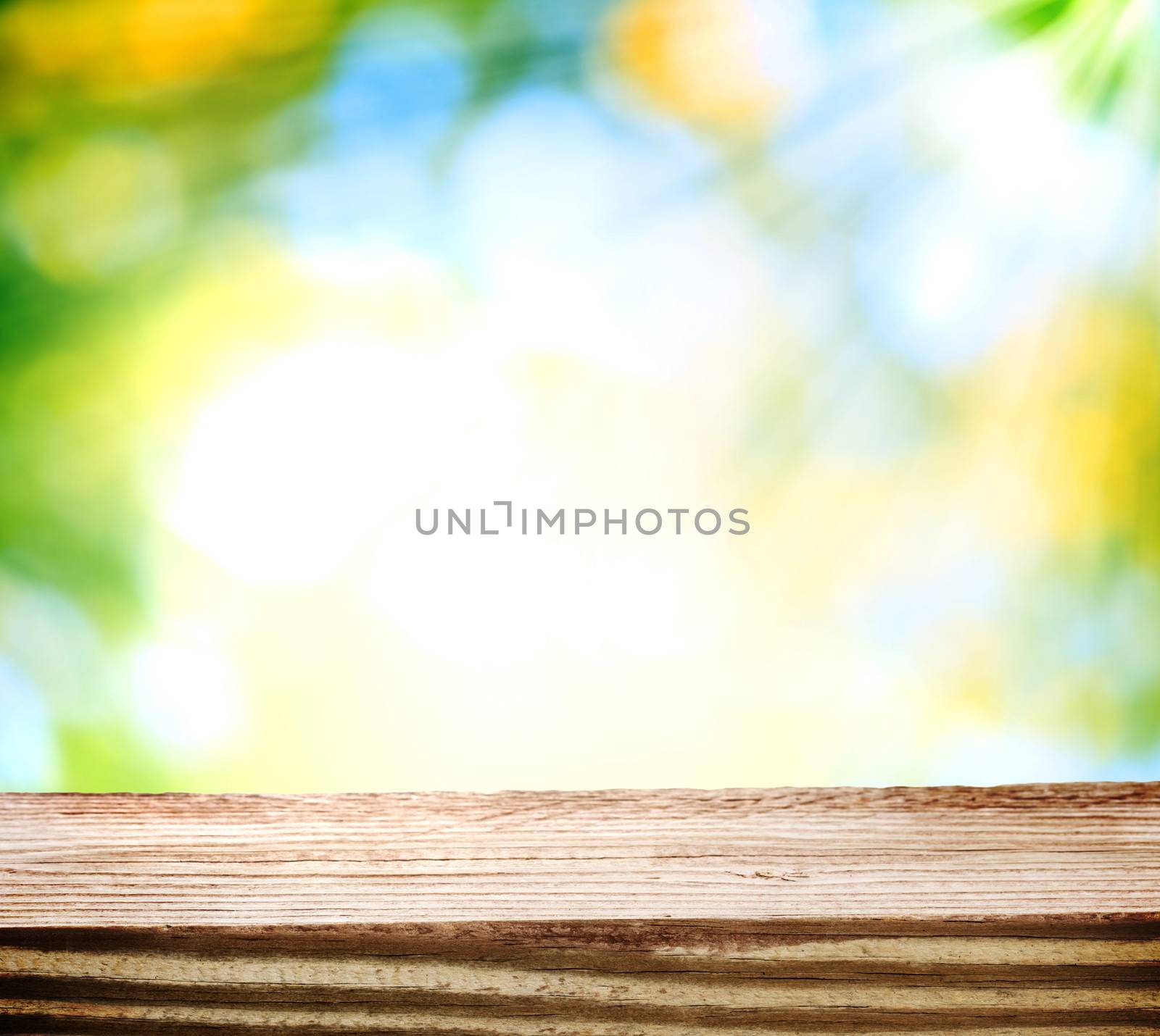 Wooden table over green and yellow shiny light background