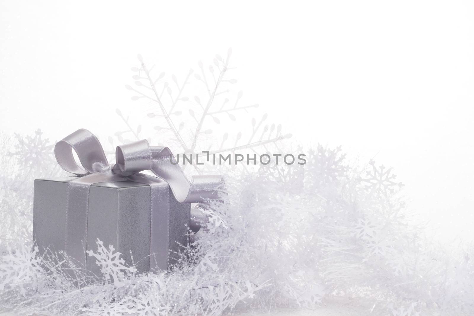 Christmas card with silver gift and decoration on white