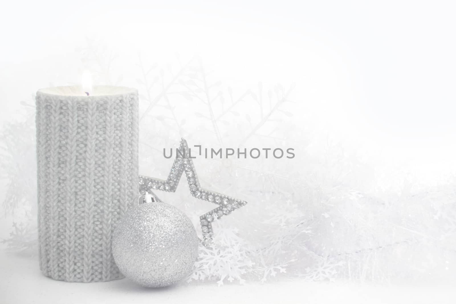 Christmas card with burning candle and decoration on white