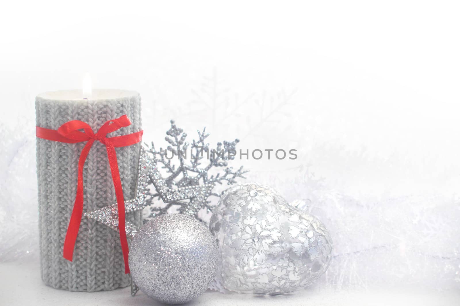 Christmas card with burning candle and decoration on white