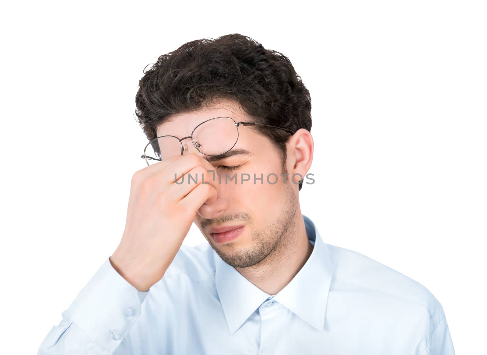 Handsome young businessman showing tired or headache gesture. Isolated on white background.