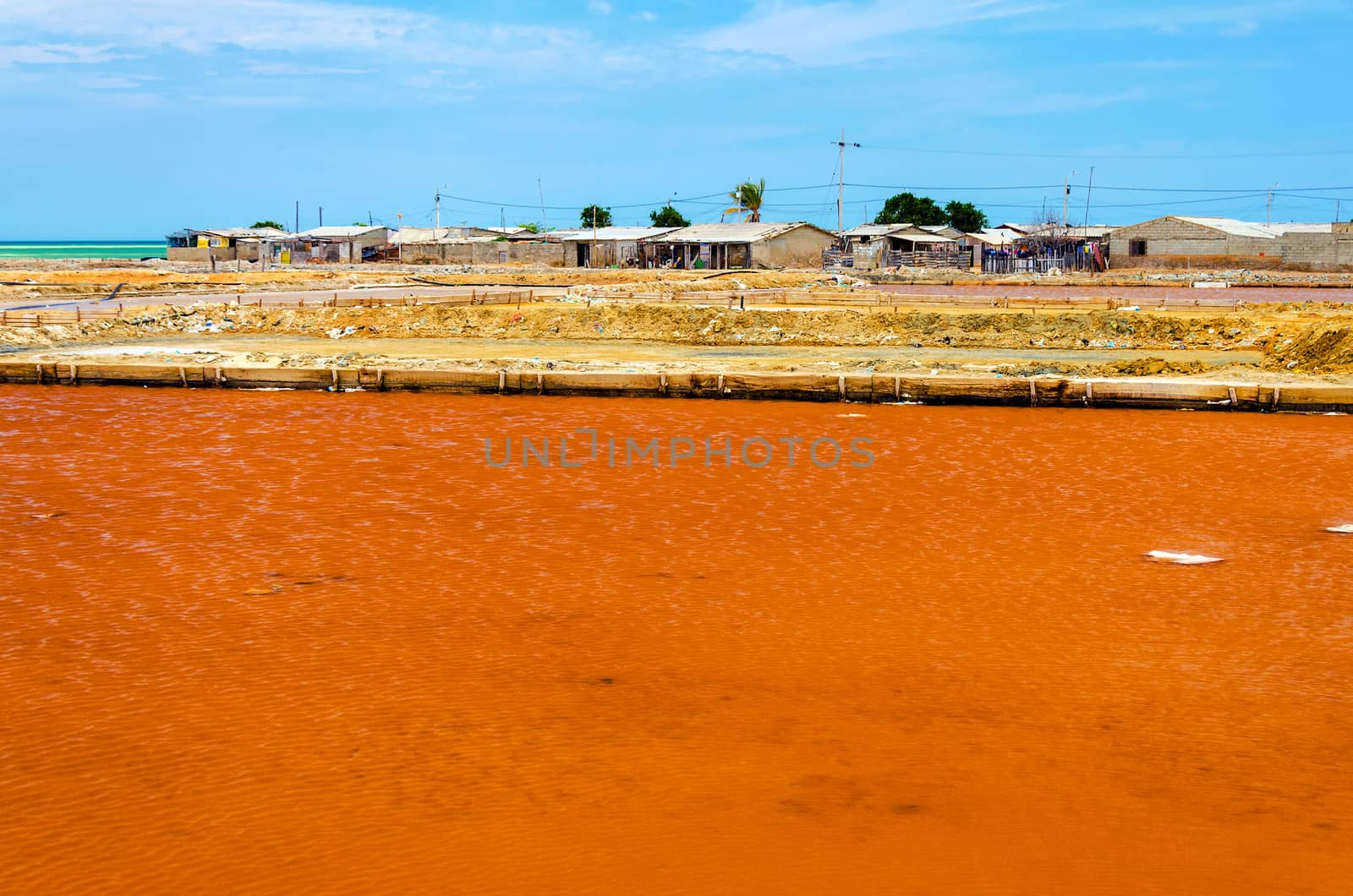Red salt pool by a slum in Manaura, Colombia