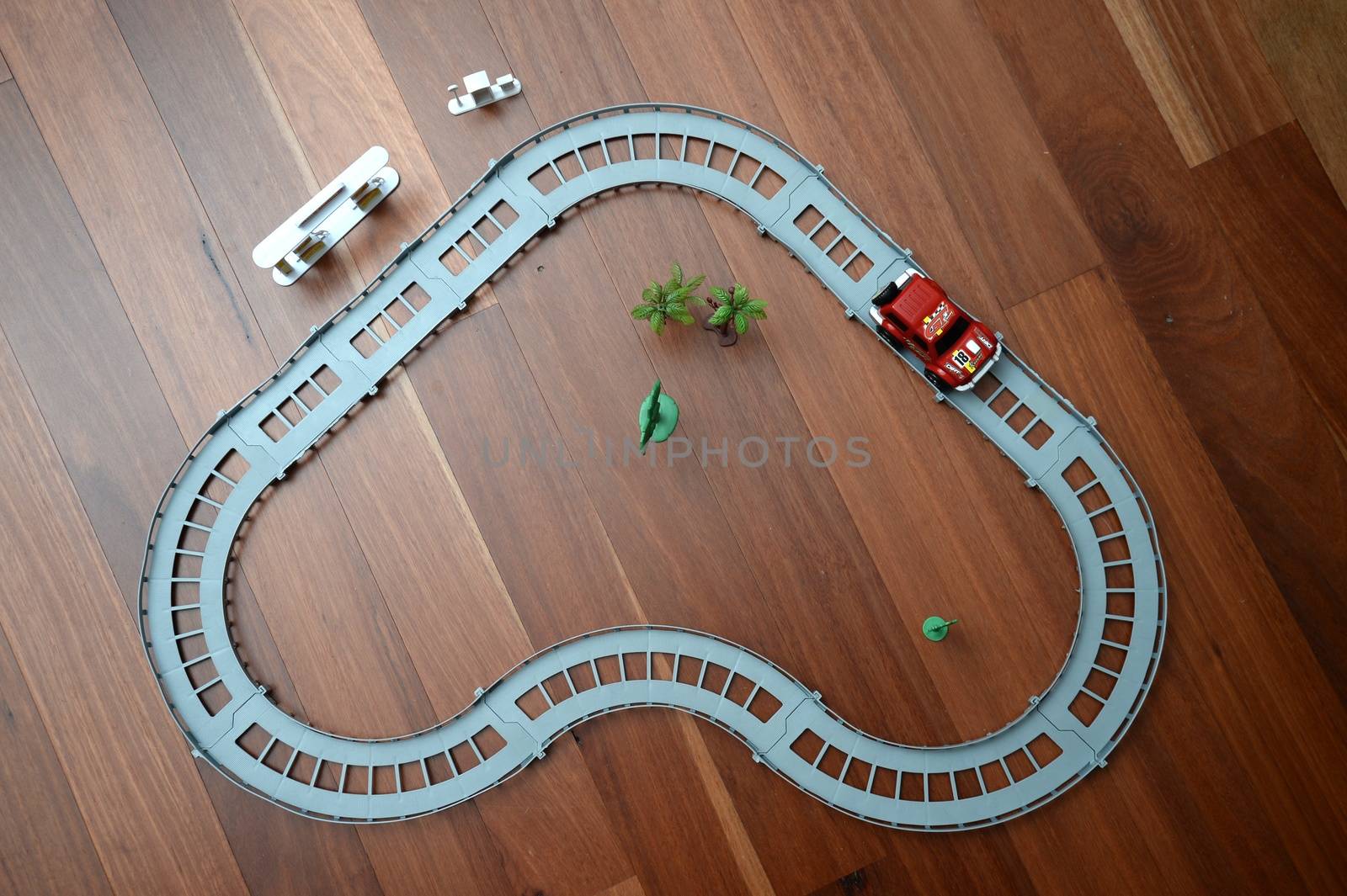 A toy race track on a wooden floor