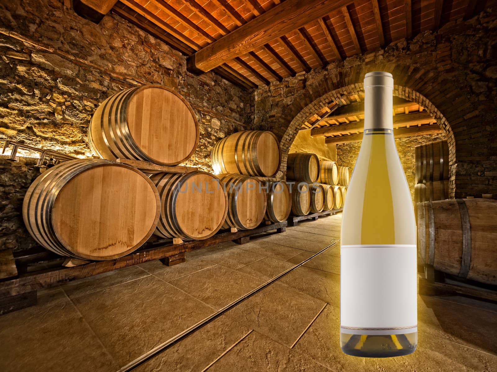 white wine bottle and oak barrels stacked in a winery cellar