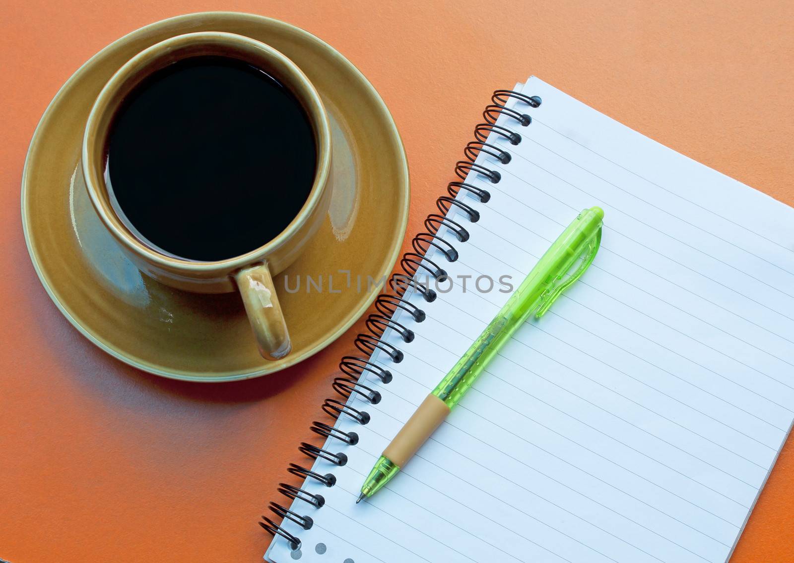 Notebooks pens note the glass coffee drinks.