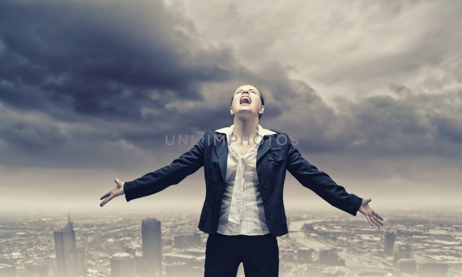 Image of businesswoman on top of building screaming