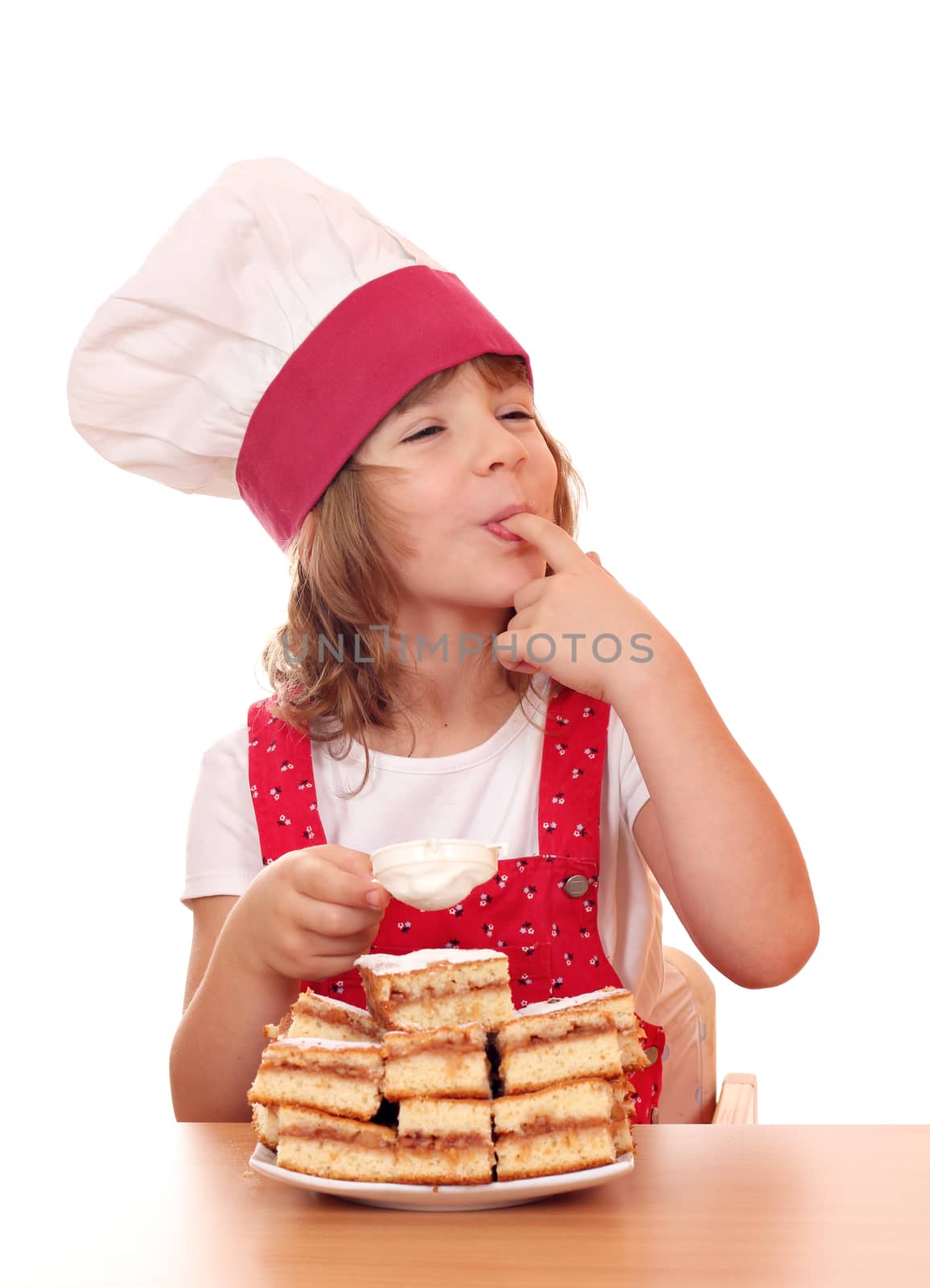 little girl cook eat sugar from apple cake