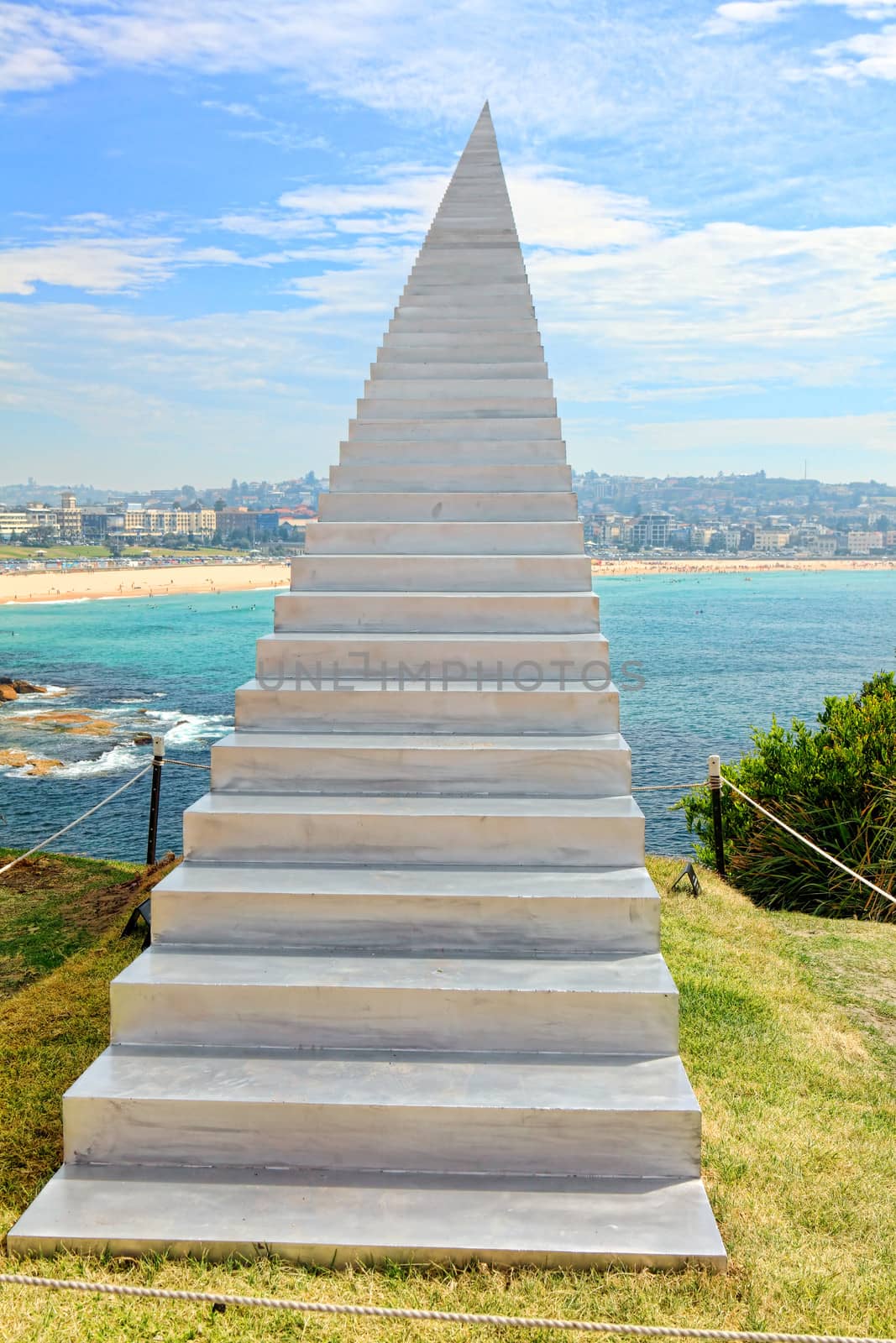 Bondi Beach, Australia - November 3,  2013: Sculpture By The Sea, Bondi 2013. Annual cultural event that showcases emerging artists from around the world  Sculpture titled 'Diminish and Ascend' by David McCracken (New Zealand).  Medium aluminium  Price $75000