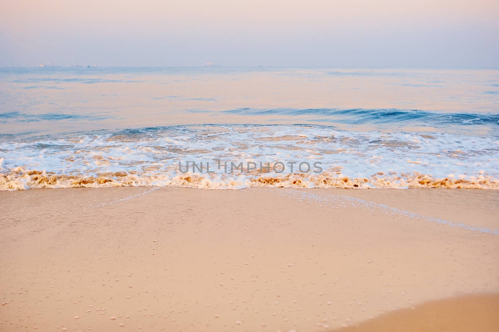 Soft wave on the sandy beach in the morning