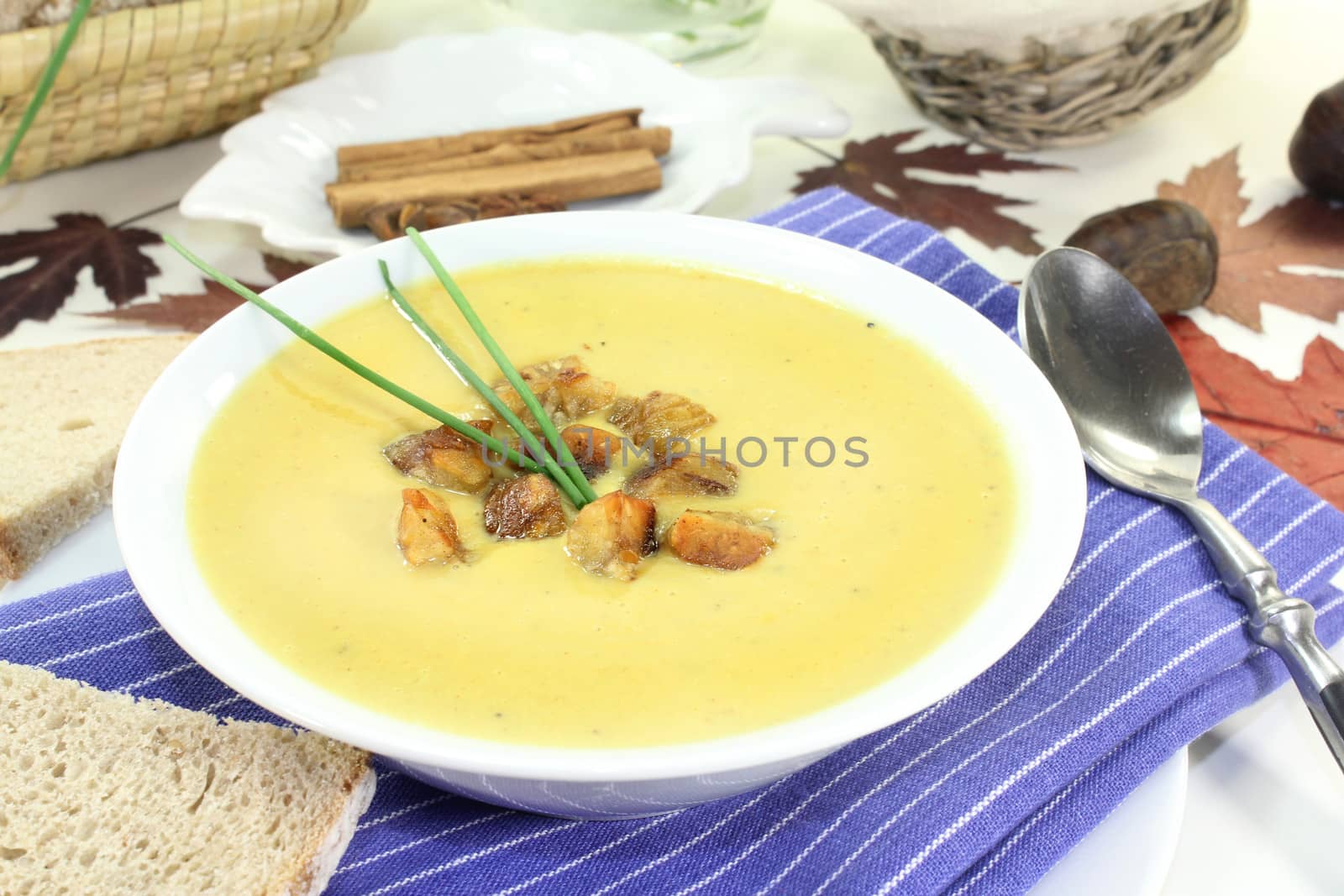 a bowl of sweet chestnut soup with roasted chestnuts and chives