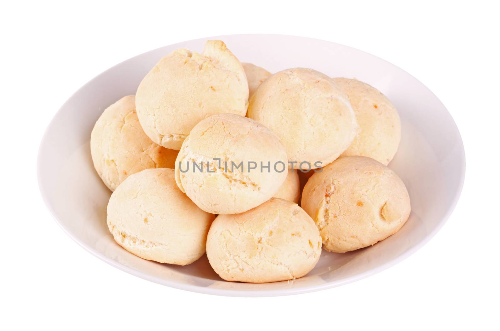 Closeup of several rolls of pan de yuca, the cheese bread made of tapioca (or yuca) flour that is very popular in Ecuador, also known as pandebono in Colombia or pao de queijo in Brazil, on a white dish