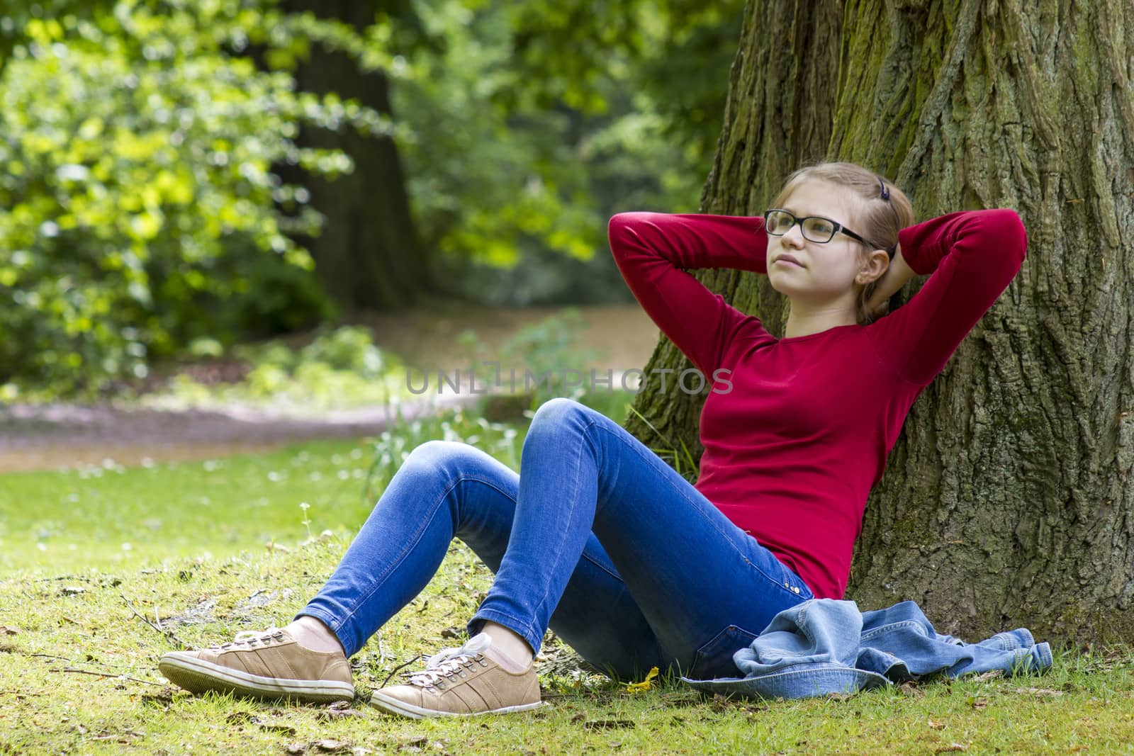 Young girl resting in park in spring day