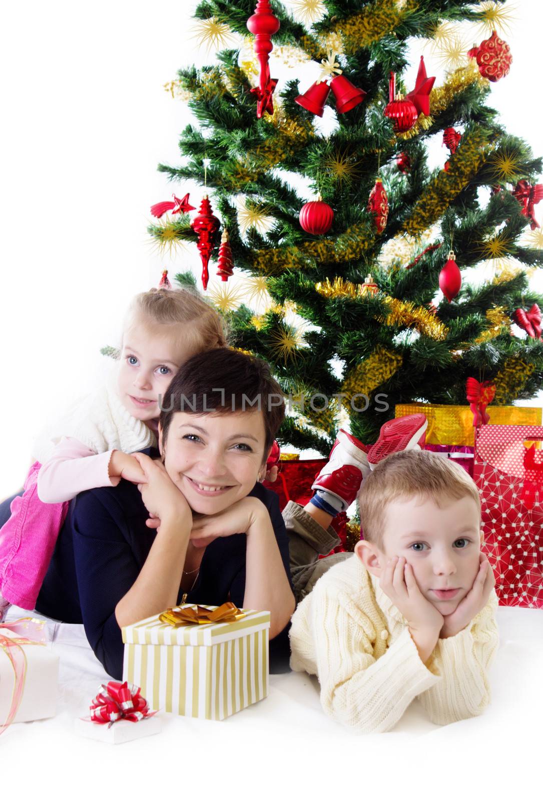 Mother with two children under Christmas tree by Angel_a