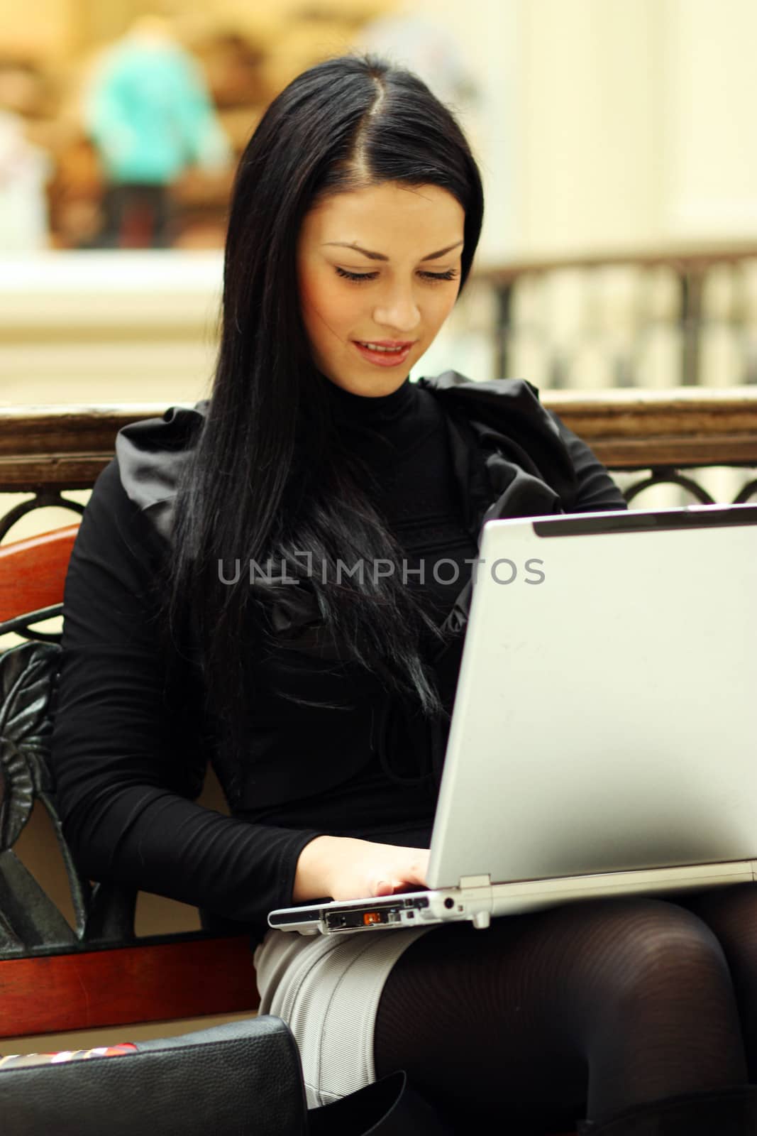 Beautiful young woman sitting on the bench