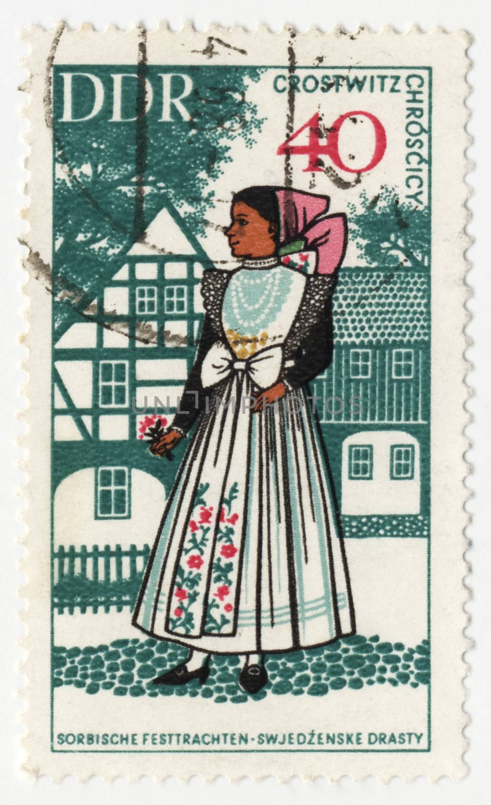 Young woman in traditional costume on post stamp by wander