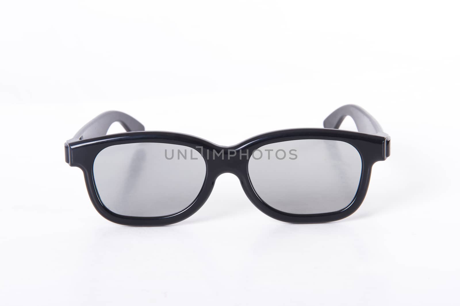 3D glasses with black frame for cinema, front view, isolated on white background.