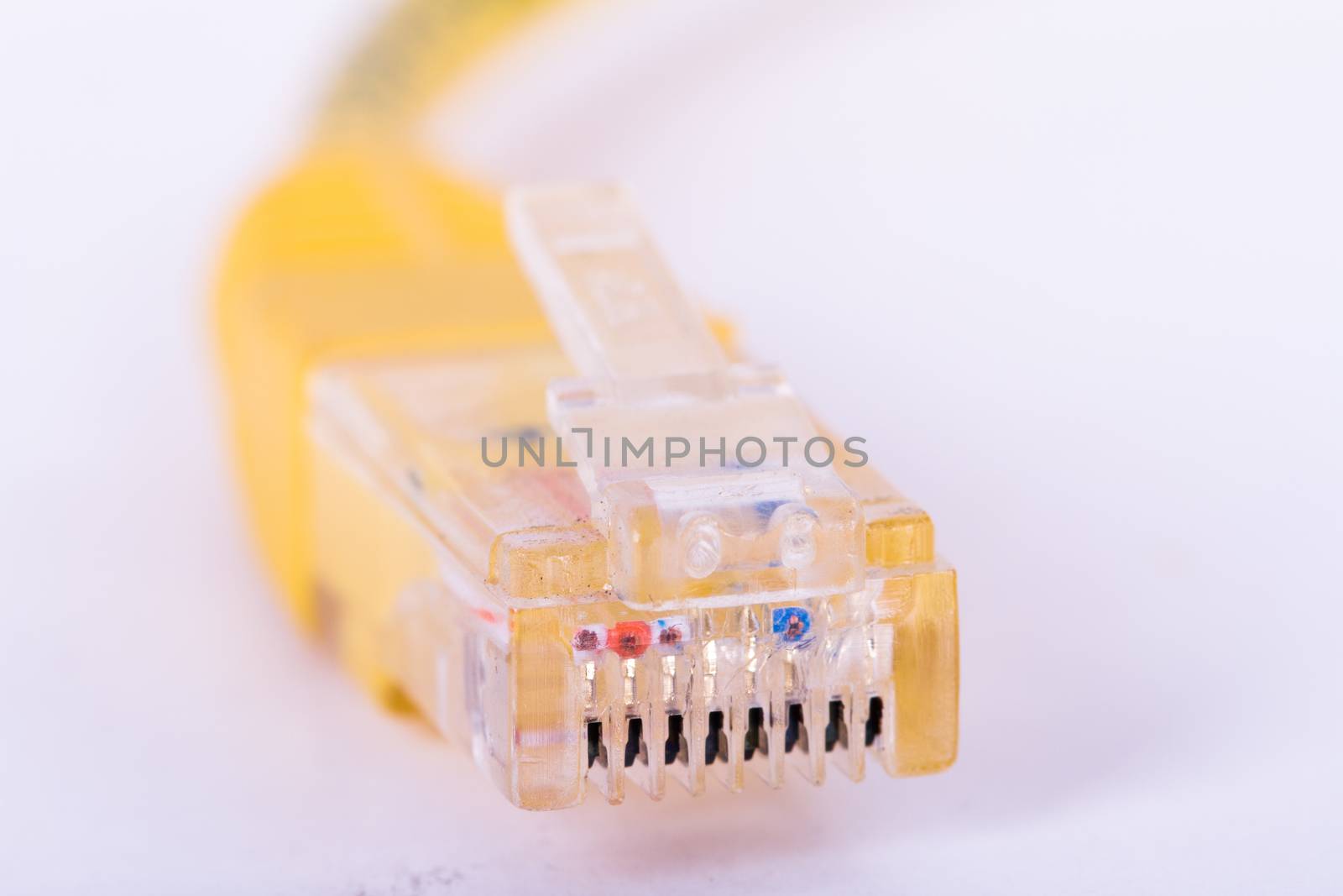 Yellow ethernet cable, isolated on white background.