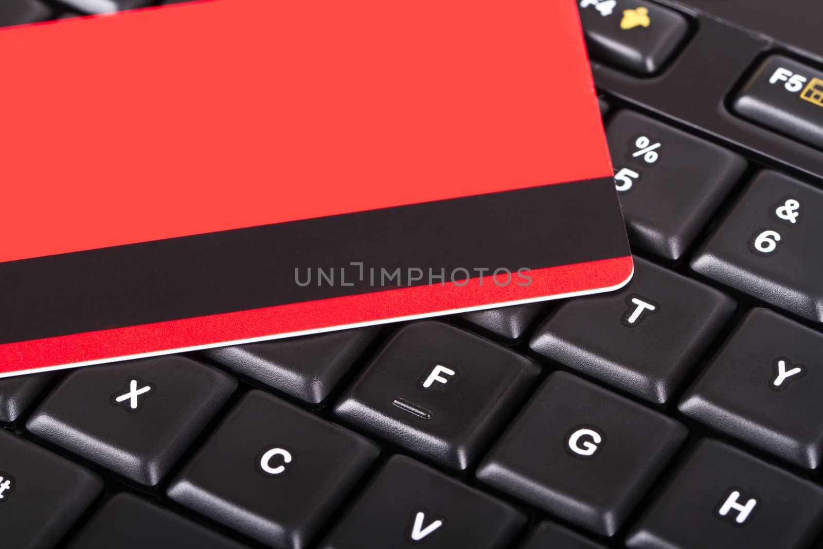 Close up view of credit card on black computer keyboard.