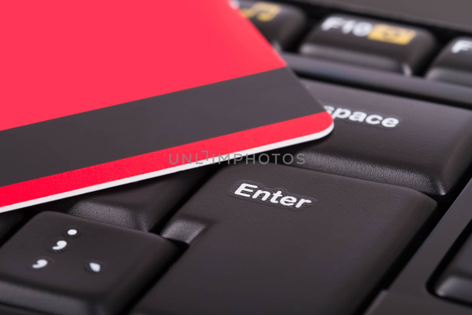 Close up view of credit card on black computer keyboard.