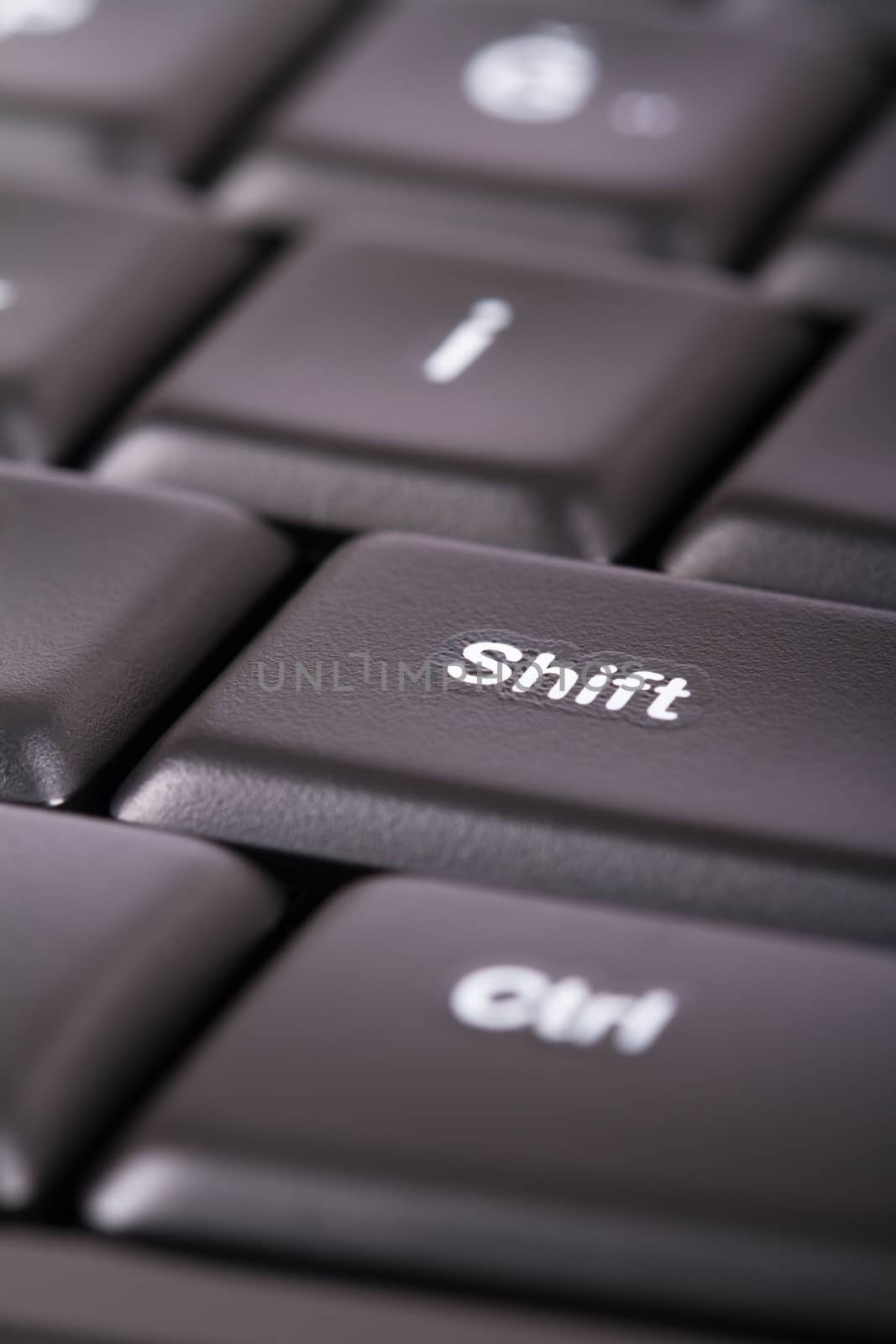 Close up view of shift button on black computer keyboard.