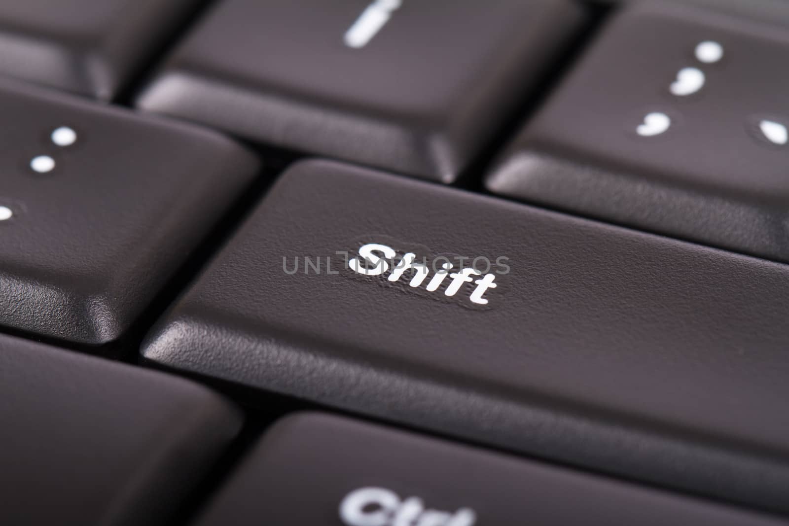 Close up view of shift button on black computer keyboard.