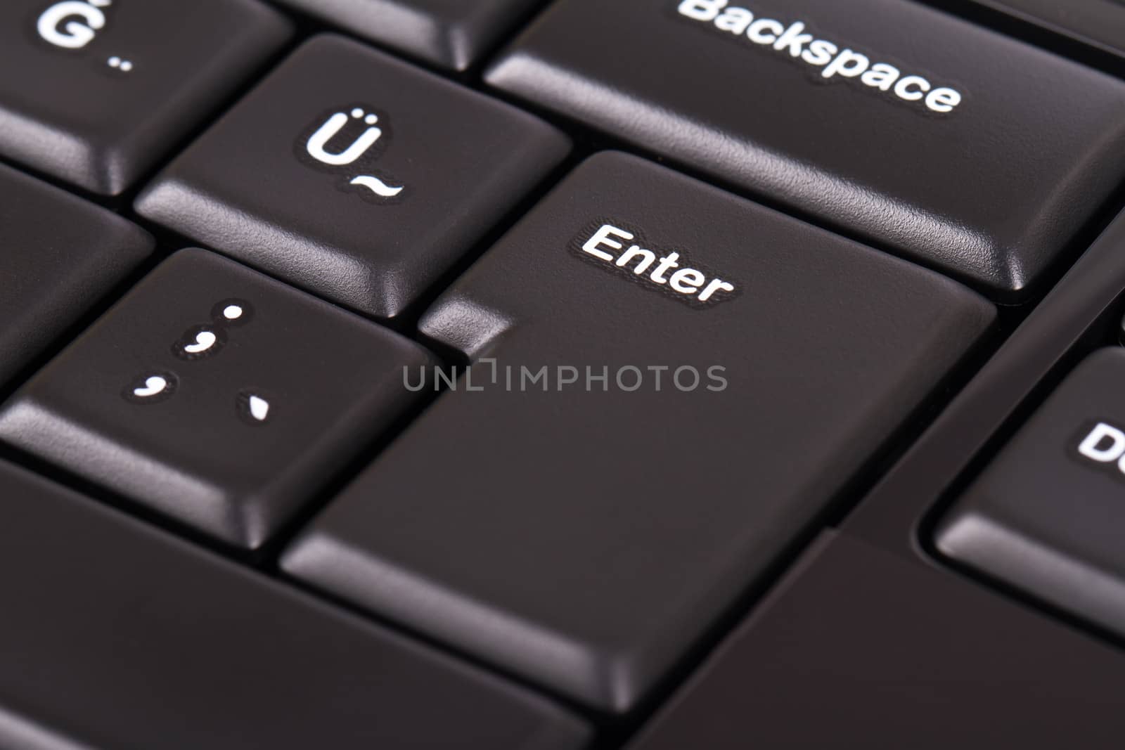 Enter button on black keyboard.