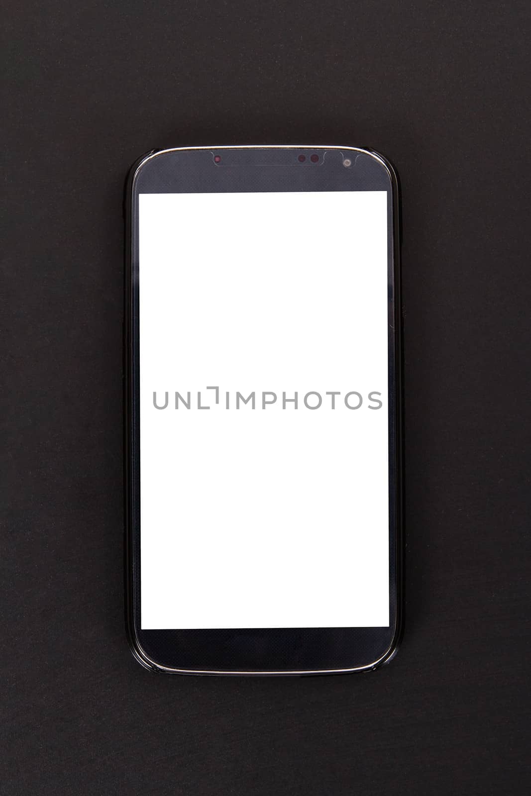 Smart phone with blank, white screen, top view on wooden table.