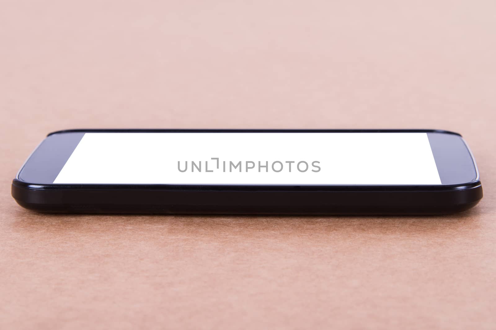 Smart phone with blank, white screen on wooden background.