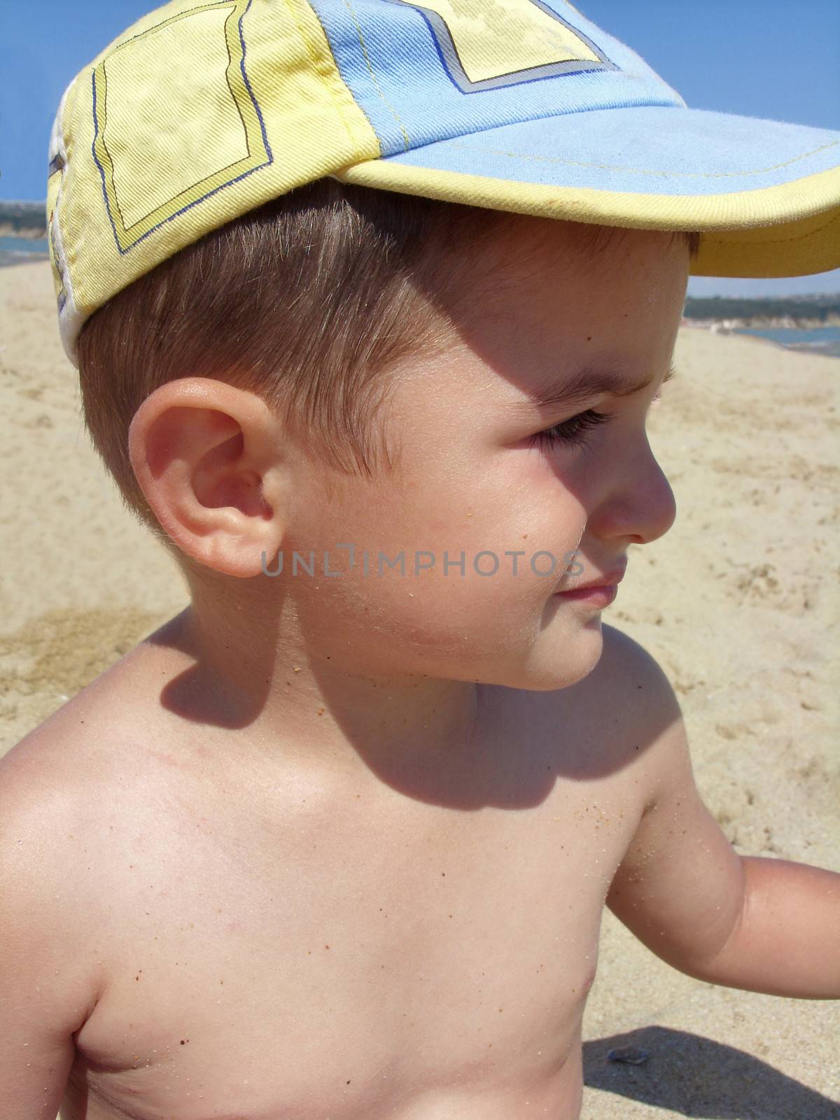 Little boy on the beach by sattva