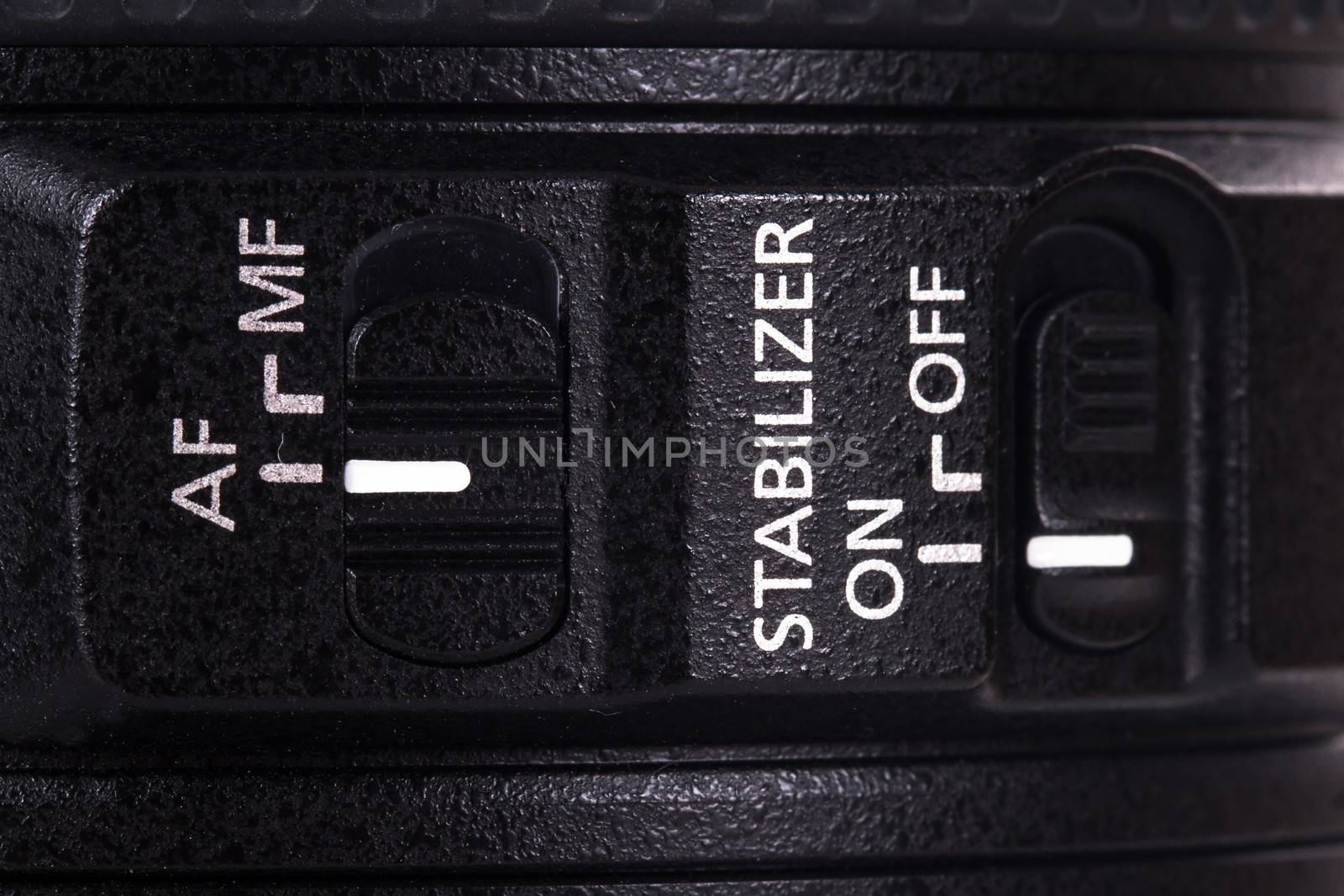 Auto focus and stabilizer modes on or off on camera lens.