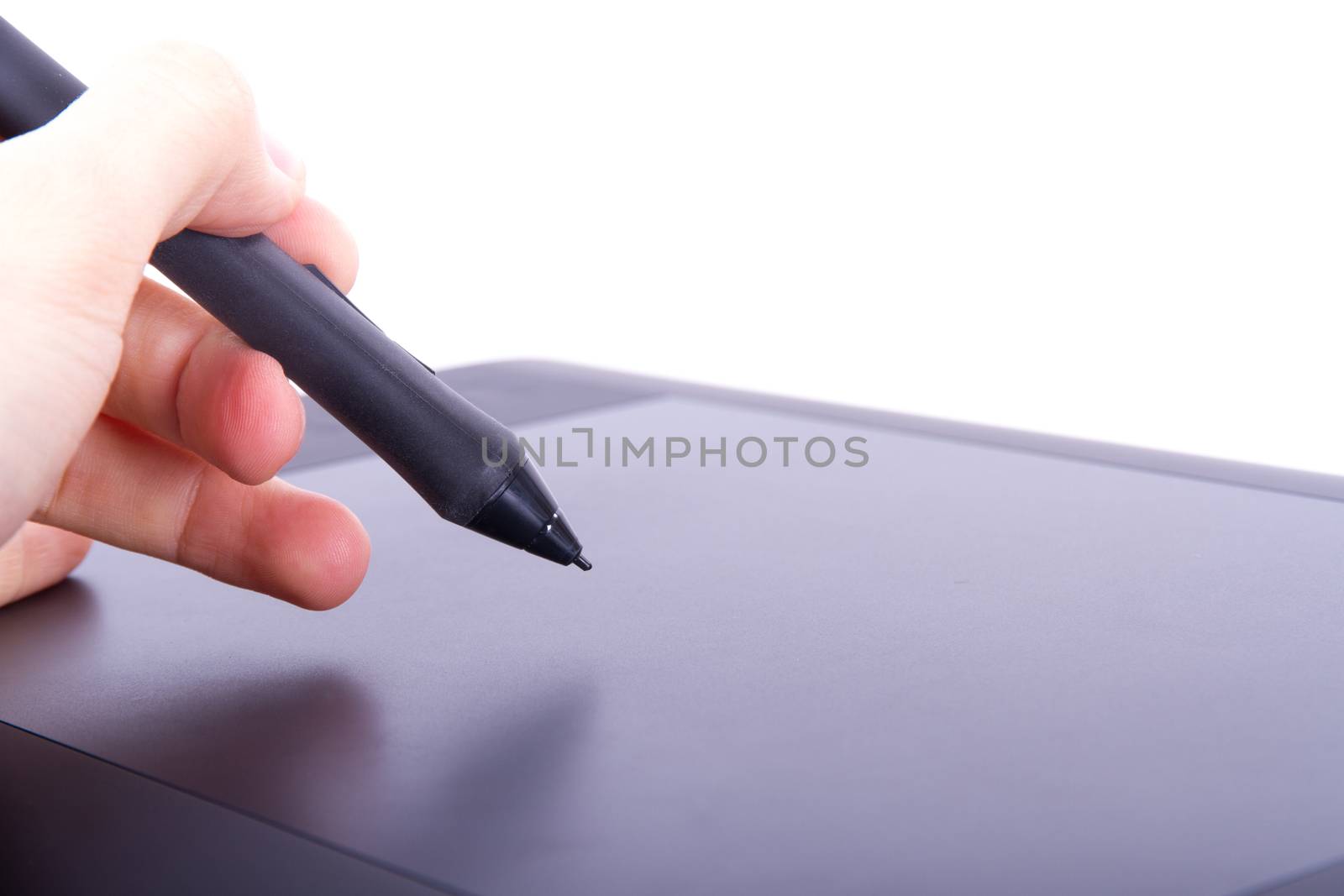 Illustrator or artist hand holding digital pen on graphic tablet, isolated on white background.