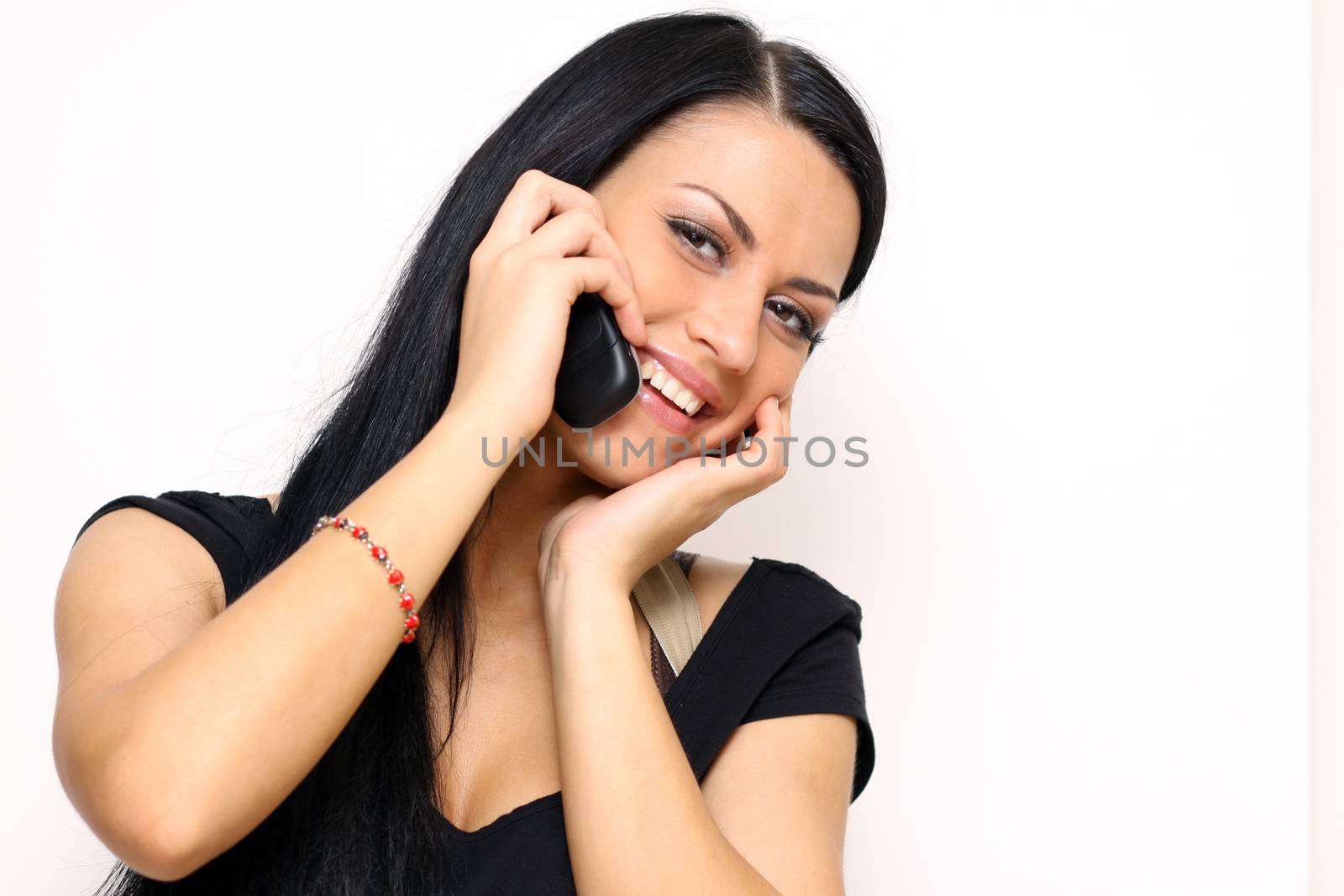Young beautiful woman talking on cell phone