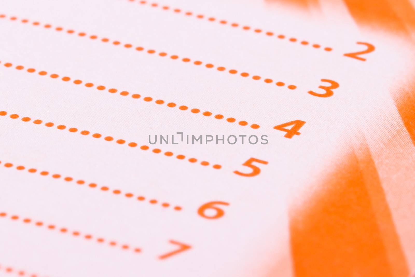 List with numbers on orange paper.