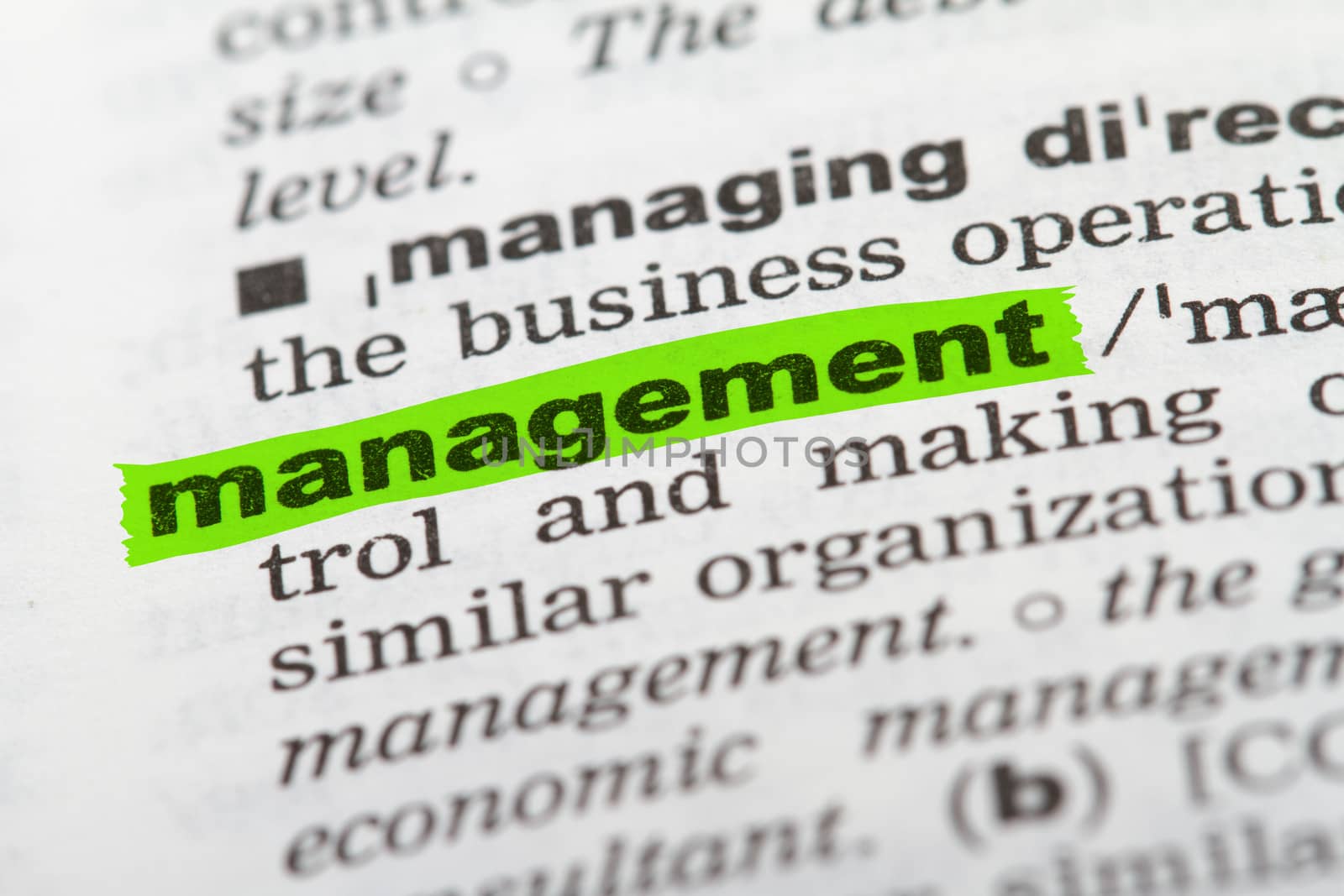 Management word highlighted with green marker on dictionary page.