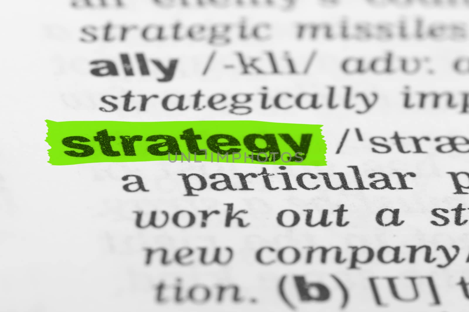 Strategy word highlighted with green marker on dictionary page.