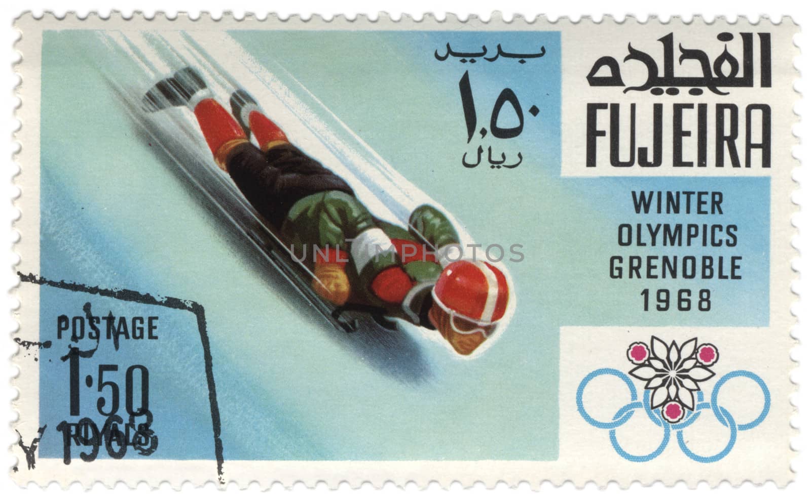 Fujeira - CIRCA 1968: A stamp printed in Fujeira shows downhill on a sled, devoted to the Winter Olympic Games in Grenoble, series, circa 1968