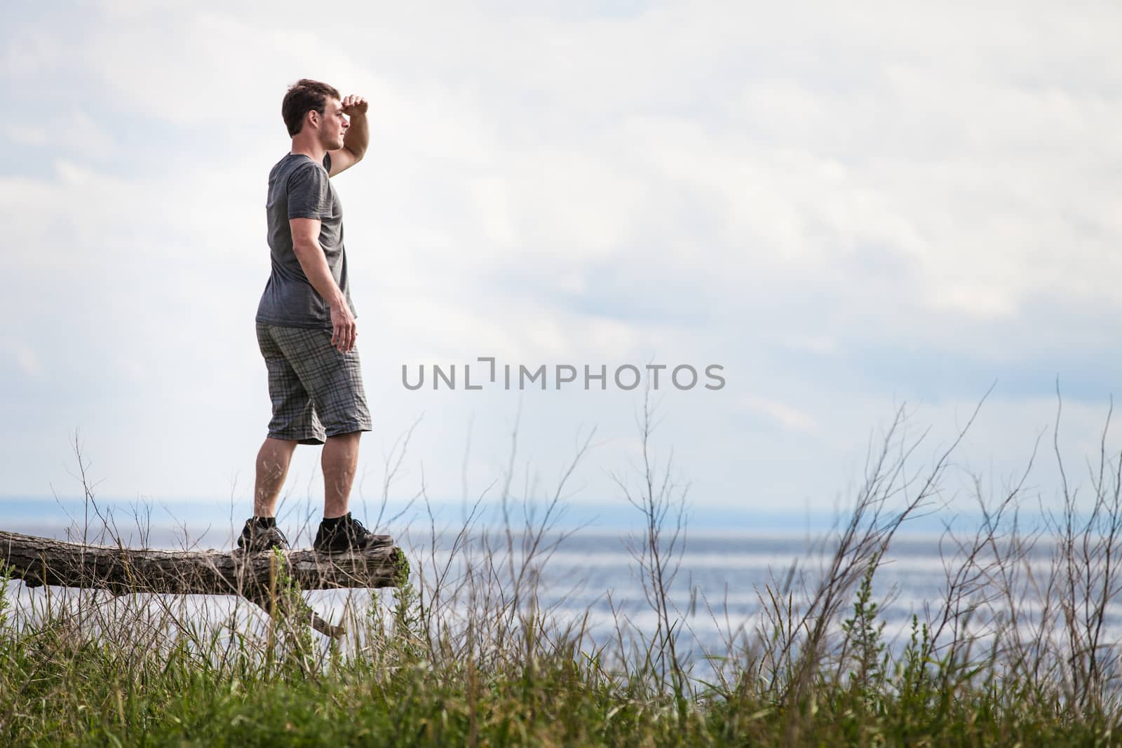 Young Adult in Nature Looking at The View With the Ocean in Background