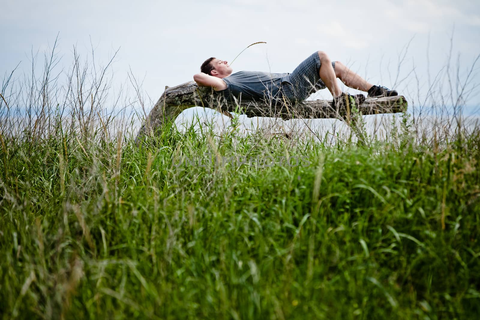 Young Adult Relaxing Peacefully in Nature by aetb