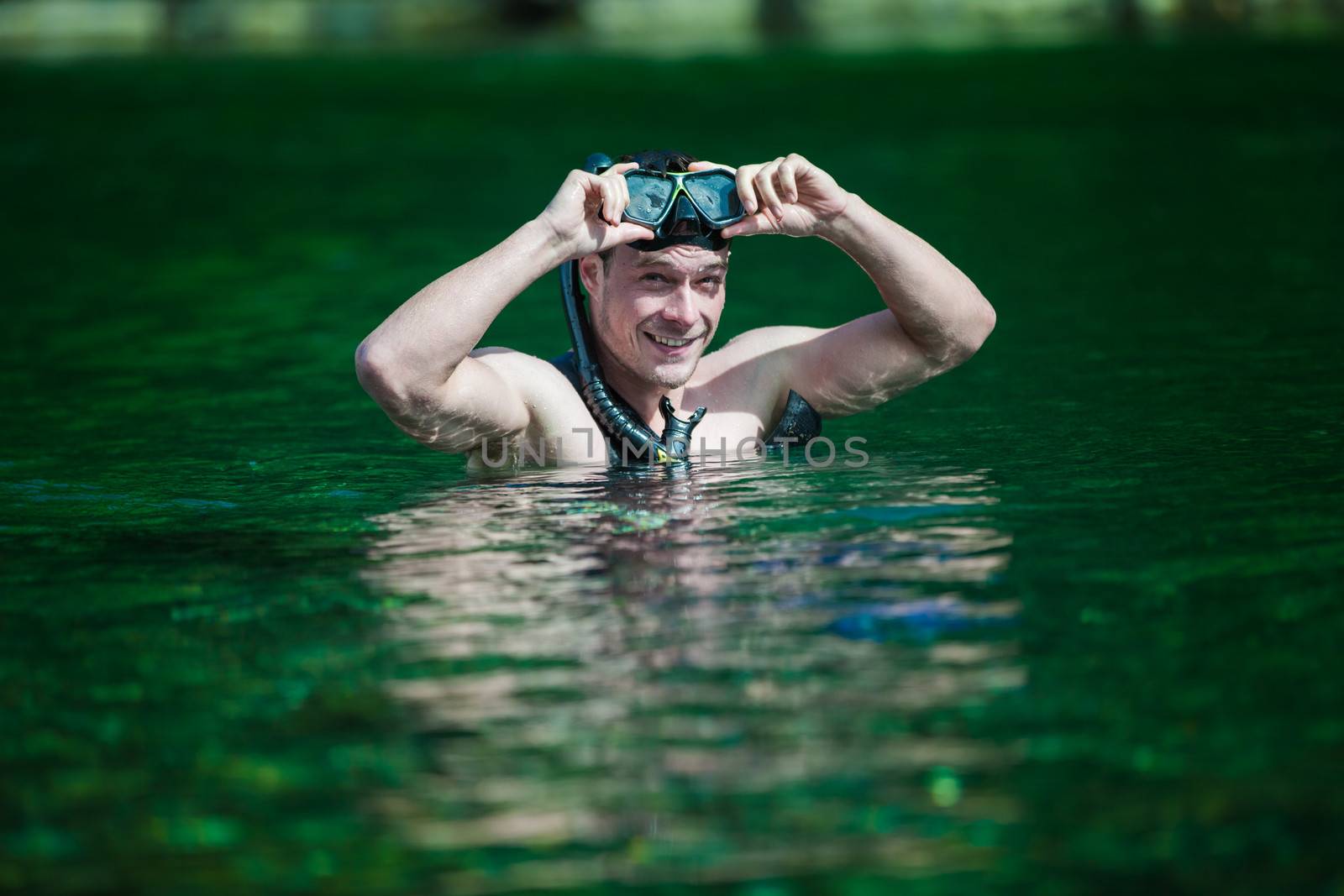 Young Adult Snorkeling in a river by aetb