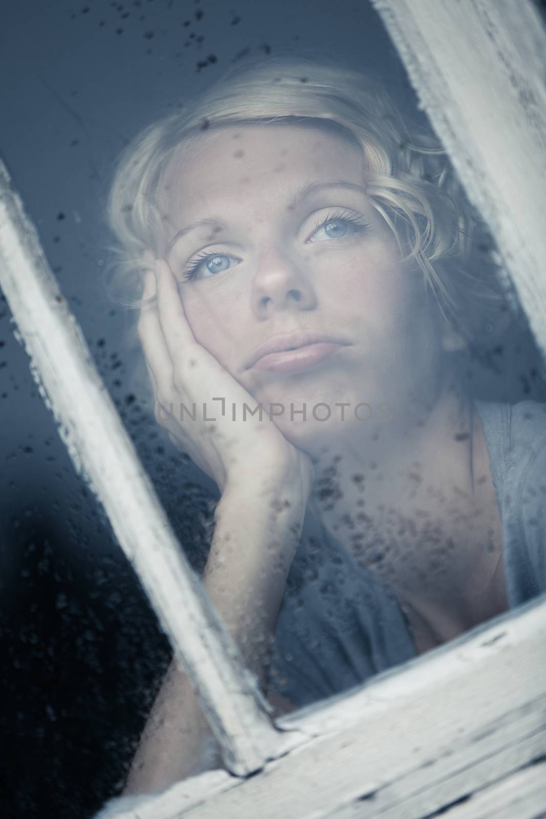 Bored Woman Looking at the Rainy Weather By the Window Frame