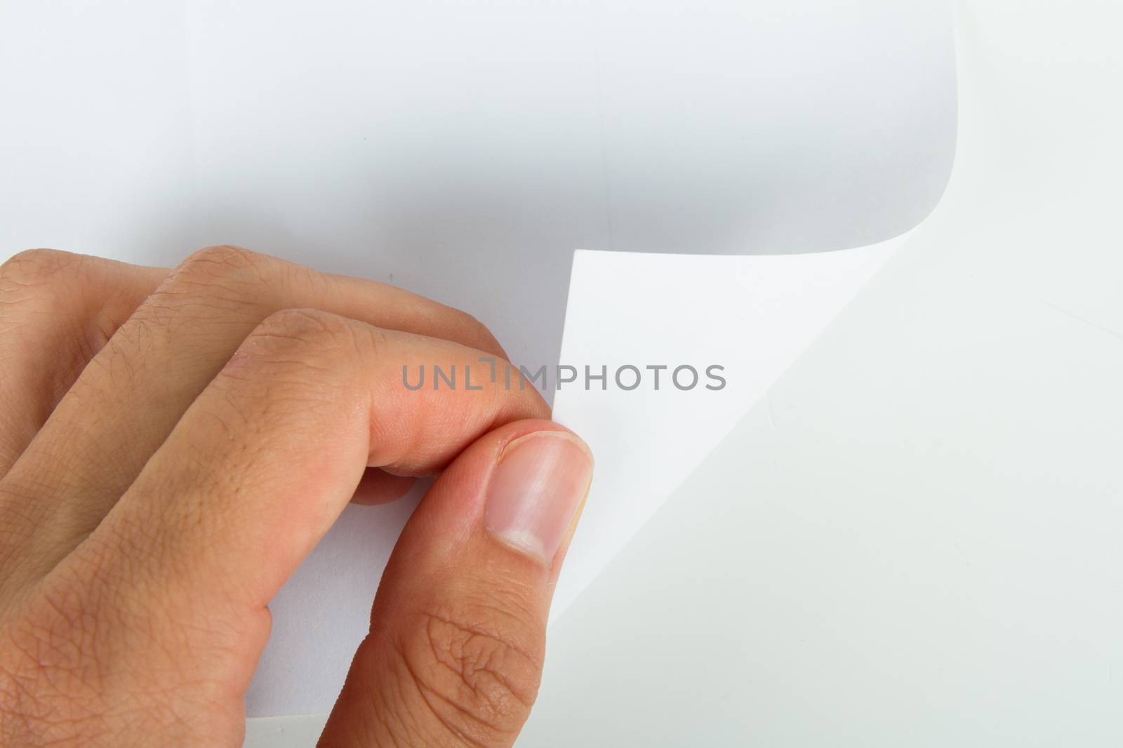 Hand turning blank page, isolated on white background.
