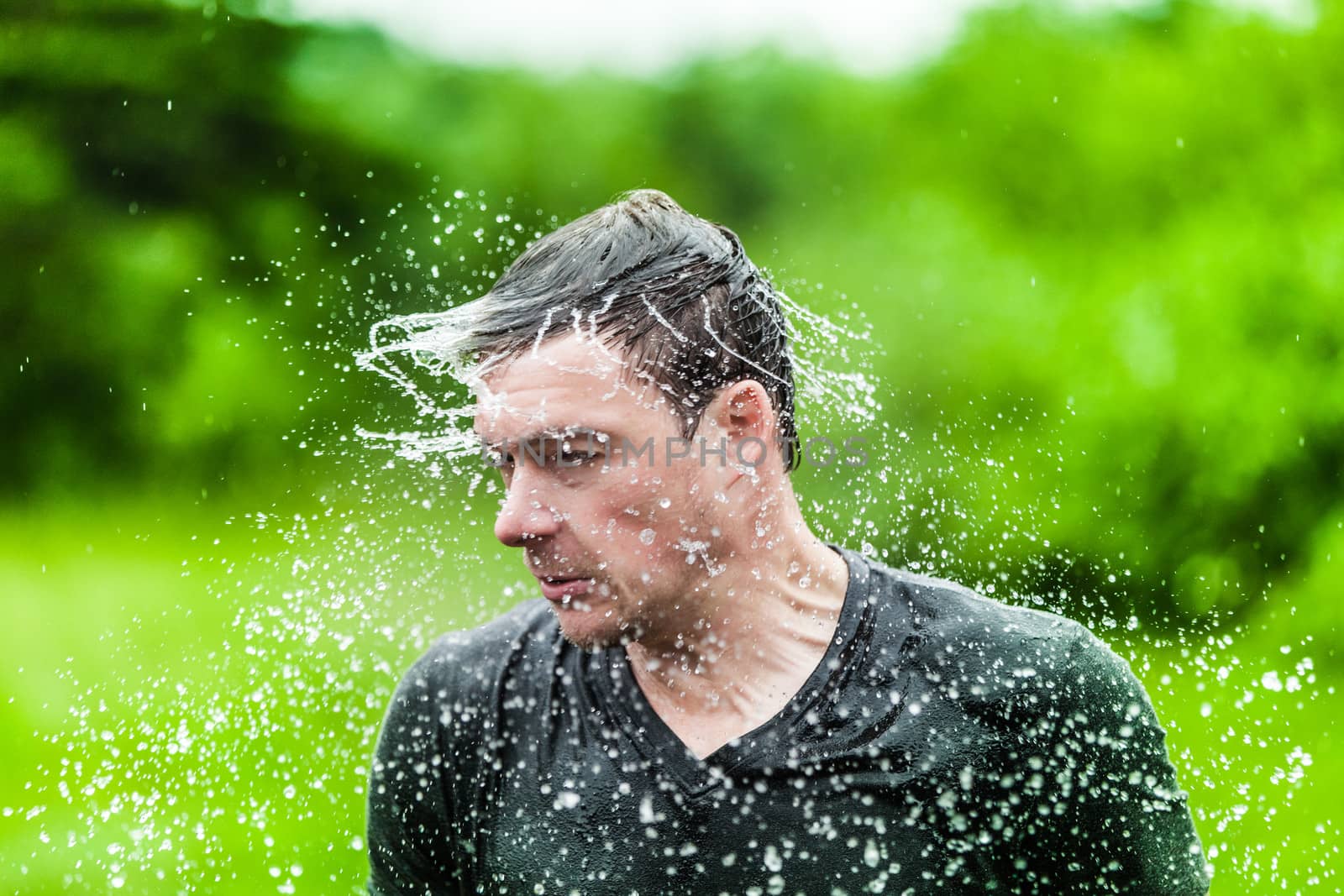 Young Adult Completely Drenched Shaking His head and Making a Funny Face