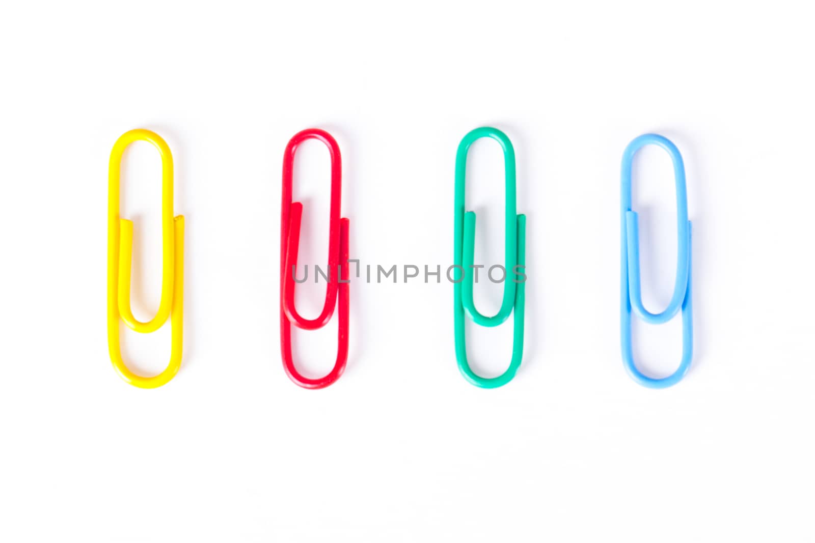 Multi colored paper clips, isolated on white background.