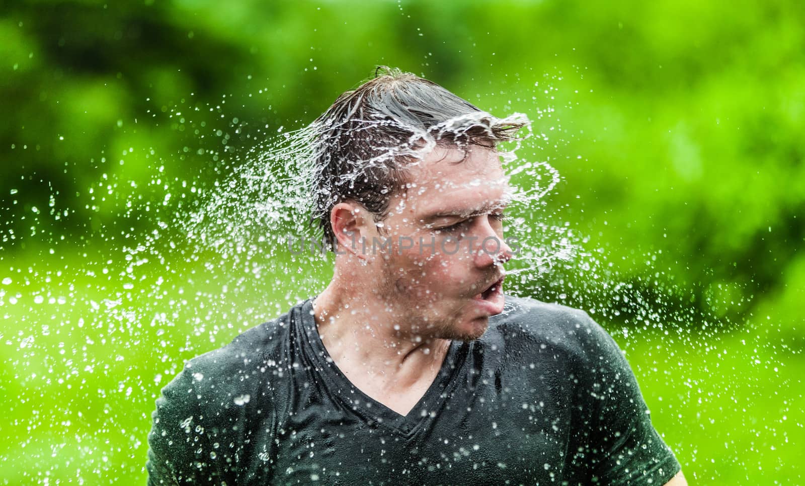 Young Adult Completely Drenched Shaking His head and Making a Funny Face