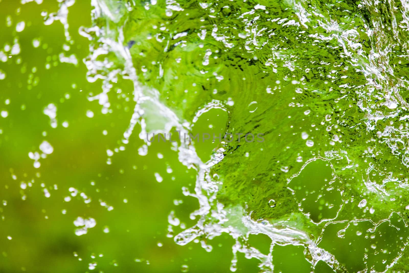 Falling Water Splash over Green Abstract Background
